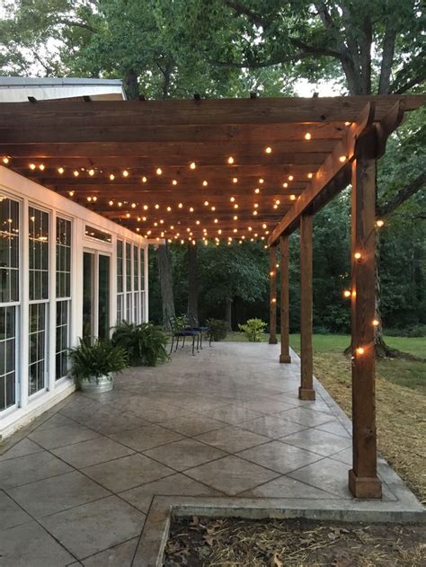 Pergola With Stained Wood And String Lights In 2024 Backyard Patio