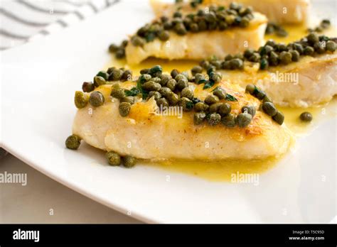 Seared Grouper Fillets with Lemon-Caper Butter: Four whitefish fillets ...