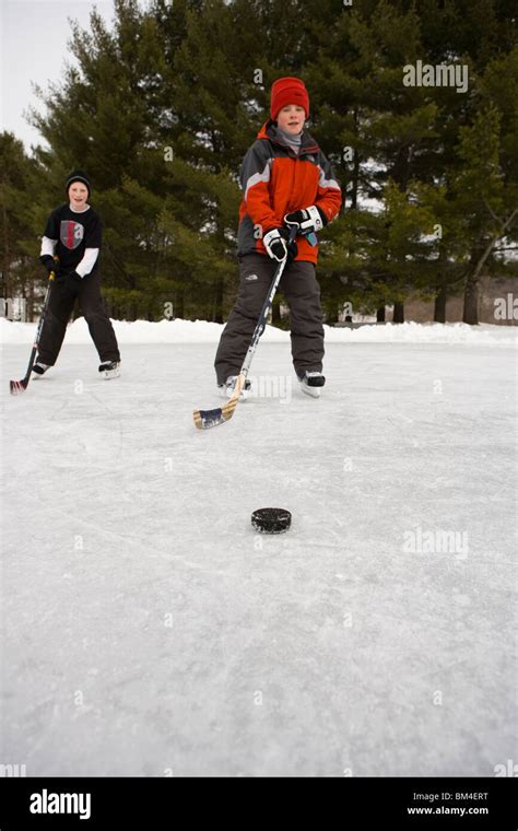 Boys Playing Hockey On A Frozen Pond In Quechee Vermont Stock Photo