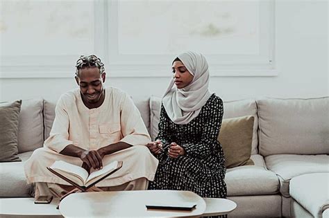 Muslim Couple In Africa Reading Quran During Ramadan At Home Photo