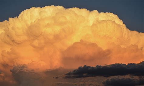 Orangewith black storm clouds at the base Sunset Clouds Photograph by Helen Christake - Fine Art ...