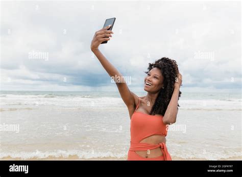 Happy Beautiful Woman Taking Selfie Through Mobile Phone At Beach Stock