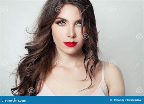 Elegant Model Woman With Long Brown Hair And Red Lips Make Up On White