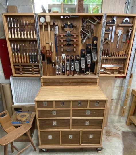 A Wooden Cabinet Filled With Lots Of Tools