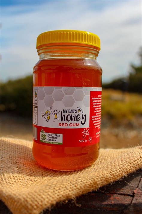 A Jar Of Honey Sitting On Top Of A Table