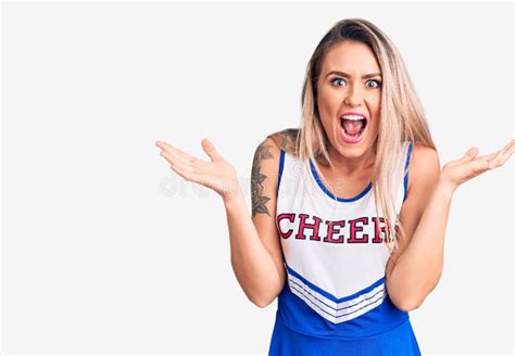 Young Beautiful Blonde Woman Wearing Cheerleader Uniform Celebrating