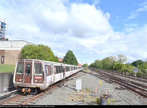 An Older Metro 2K Series Train Arrives Into Twinbrook Station On The