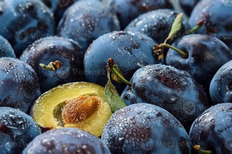 Plums and prunes halves, background of fresh organic fruits in water