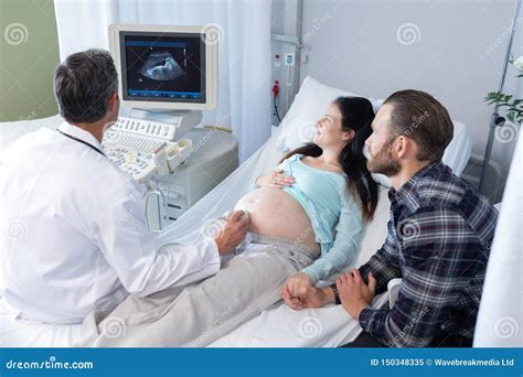 Doctor Doing Ultrasound Scan For Pregnant Woman In Hospital Stock Image