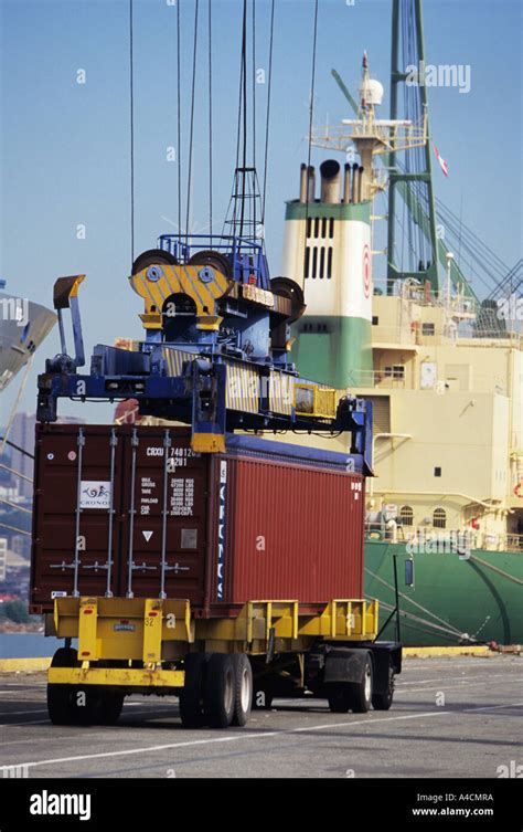 Unloading Shipping Containers From A Ship Stock Photo Alamy