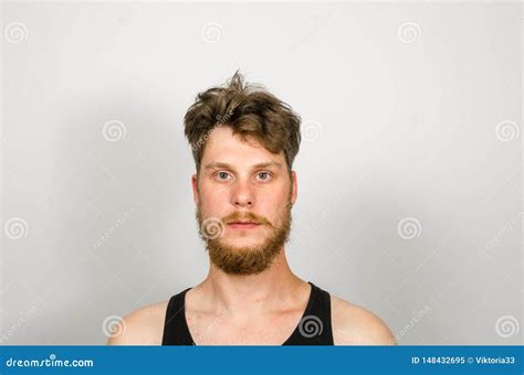 Portrait Of Young Bearded Unkempt Scruffy Man On Gray Background Stock