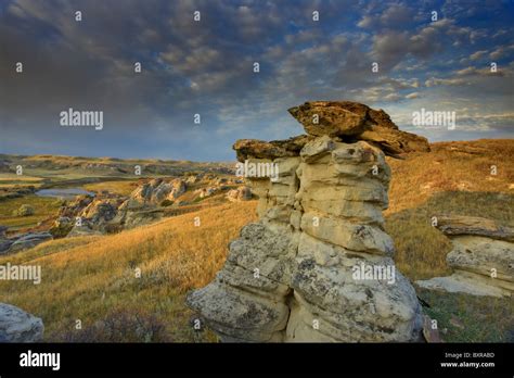 Capped Hoodoos and Dramatic Sky, Writing-On-Stone Provincial Park, Alberta, Canada Stock Photo ...