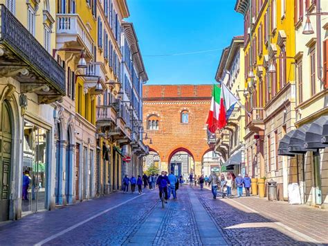 Crowded Via Vittorio Emanuele Ii Street With Acrades Of Palazzo Dell