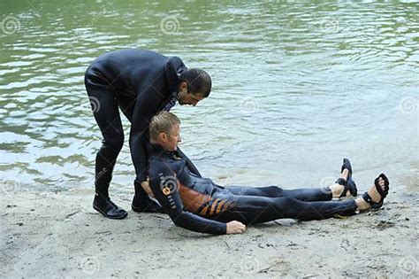 Men In A Wet Diver Suit Lifeguards Showing Right Way Of Pulling