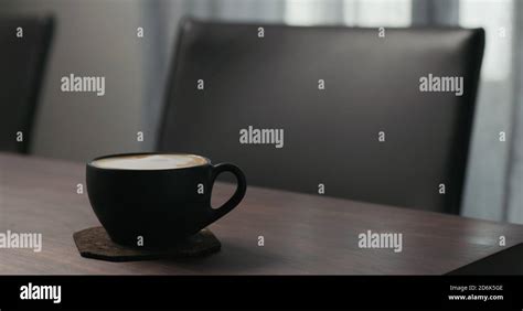 Cappuccino In Black Cup On Walnut Table Wide Photo Stock Photo Alamy