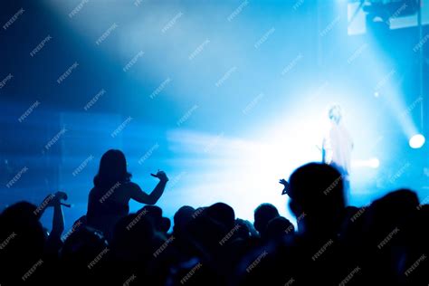 Premium Photo | Silhouette of concert crowd in front of bright stage lights