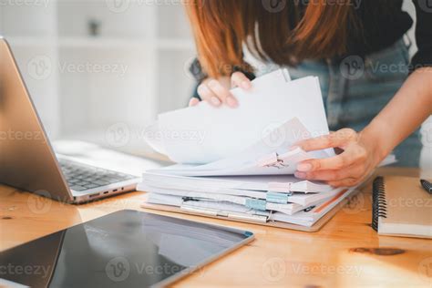 Businesswoman Working In Stacks Of Paper Files For Searching And