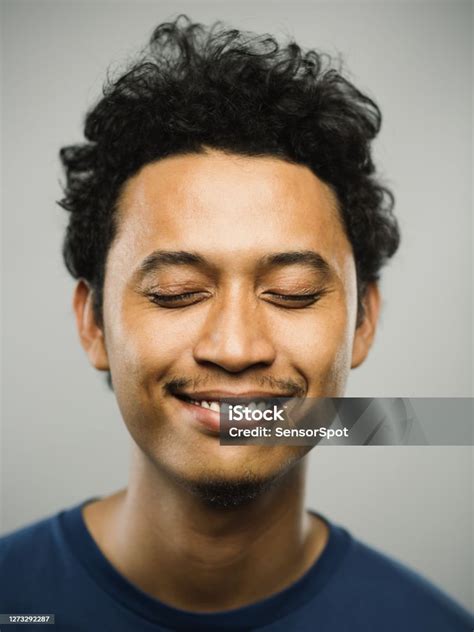 Portrait Of Real Pakistani Man With Happy Expression And Eyes Closed