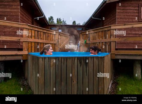 Couple Of Happy Girlfriends Having Fun And Enjoying The Benefits Of The Hot Tub Stock Photo Alamy