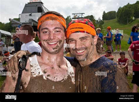 Two Tough Mudder Participants Smile After Crossing The Finish Line