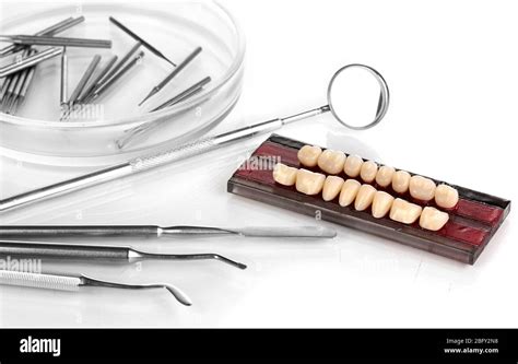 denture with dental tools isolated on white Stock Photo - Alamy