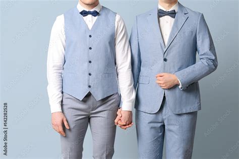 Happy Gay Couple Holding Hands Together On Color Background Stock Photo Adobe Stock