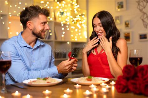 Man Proposing With Ring Delighted Woman At Dinner Stock Image Image