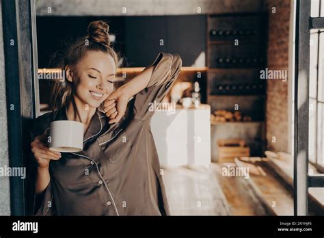 New Day Happy Beautiful Brunette Female Stretching With Cup Of Coffee In Her Hand Enjoying