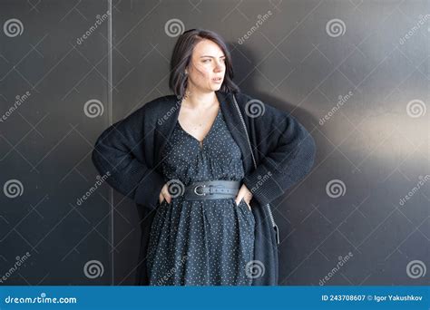 Young Beautiful Woman Pose In Black Dress Standing Outside Stock Image