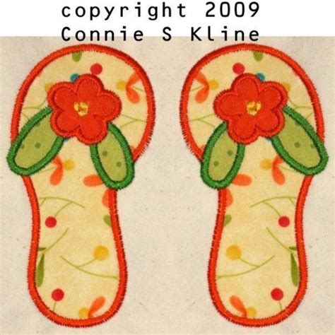 Pair Of Flip Flops With Flower Appliqued On Them