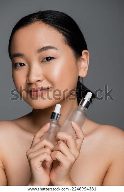 Pleased Asian Woman Naked Shoulders Holding Stock Photo