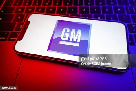 In this photo illustration, a General Motors logo seen displayed on a ...