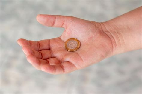 Premium Photo One Real Coin In The Palm Of A Persons Hand Hand