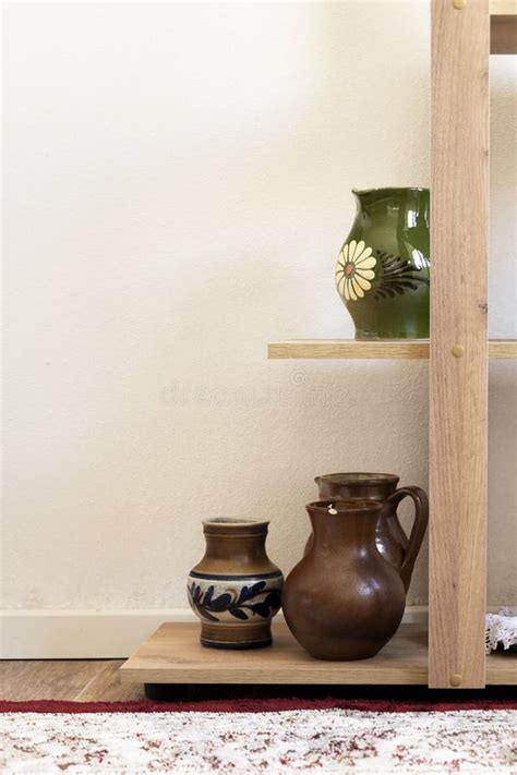 Different Ceramic Pottery Vases On Shelves Interior Design Stock Photo