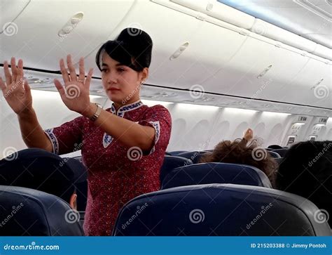 A Female Flight Attendants Show Passengers About Safety Instruction On