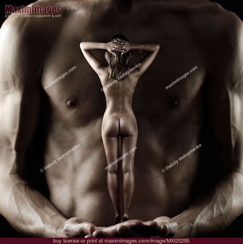 Muscular Man Holding Nude Woman In His Hands Stock Photo MXI