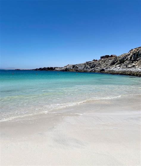 The Beach Is Clean And Clear For Us To See As People Are In The Water