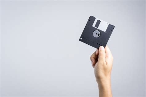 Premium Photo Hand Holding Floppy Disk