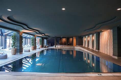 Premium Photo | Swimming pool located in center luxury hotel room