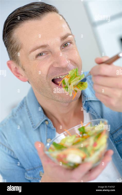 man eating salad Stock Photo - Alamy