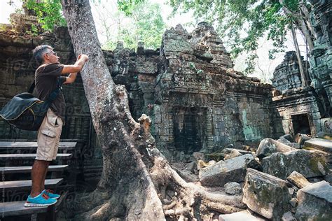 Tourist Taking Photo In Ta Prohm Temple In Cambodia By Stocksy