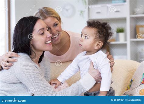 Same Sex Couple Making A Fuss Over Baby Stock Image Image Of Calm Holding 56069391