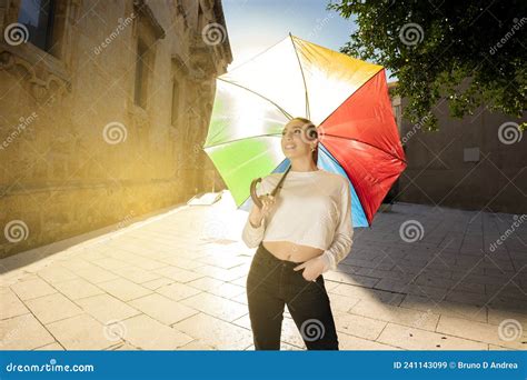 Caucasian Brunette Young Woman Holding A Colorful Umbrella In Urban