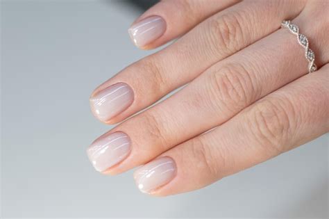 Premium Photo A Woman S Hand With A Nude Manicure On Her Nails