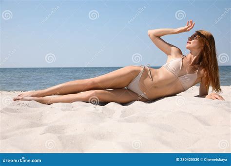 Attractive Woman With Perfect Body In Bikini Lying On Sandy Beach Near