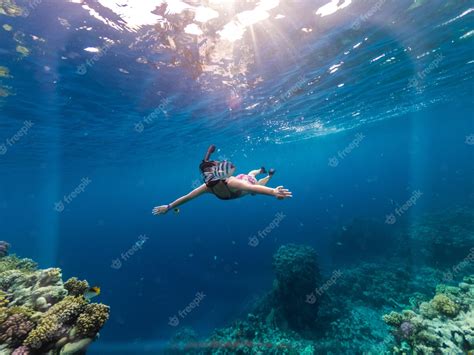 Premium Photo Young Woman Snorkeling At Coral Reef In Tropical Sea