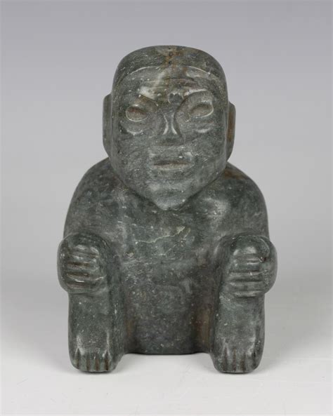 A Pre Columbian Olmec Style Carved Green Hardstone Figure Of A Seated