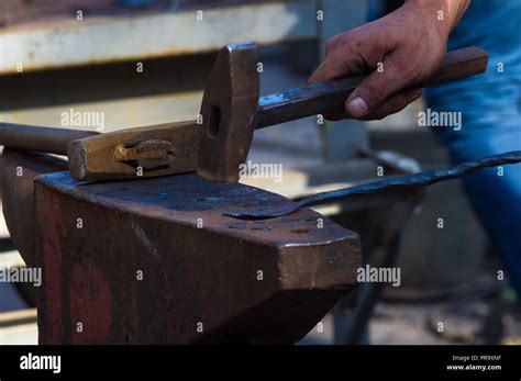 Blacksmith Performs The Forging Of Hot Glowing Metal On The Anvil Close Up Stock Photo Alamy