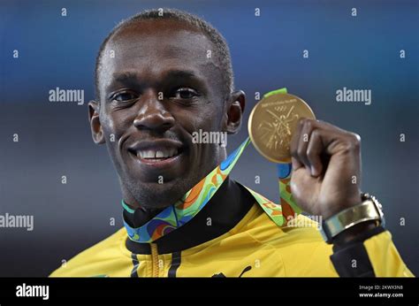 Usain Bolt Of Jamaica Pose With Gold Medal After The Mens 200 Metres