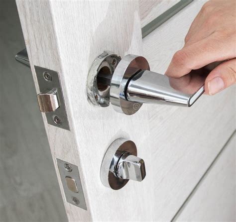 A Man`s Hand Opens An Interior Door With A Broken Doorknob Poor Quality Door Hardware Breakage